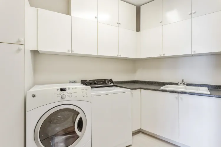 Well appointed laundry room with tons of storage, double size ceramic sink.