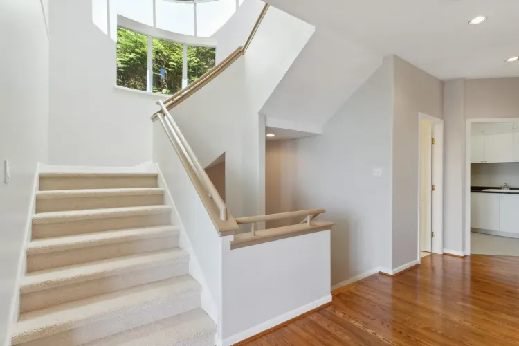 Bright well lite with natural light, open staircase to the bedroom level.